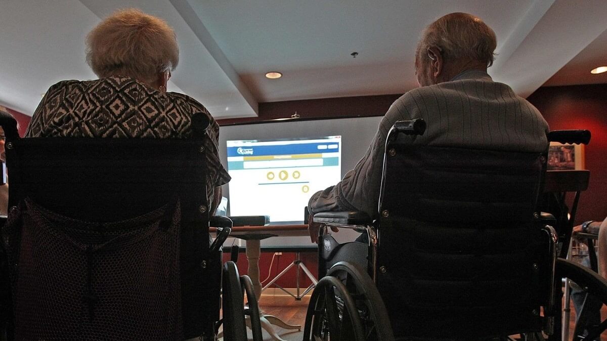 Seniors watching movie on projector