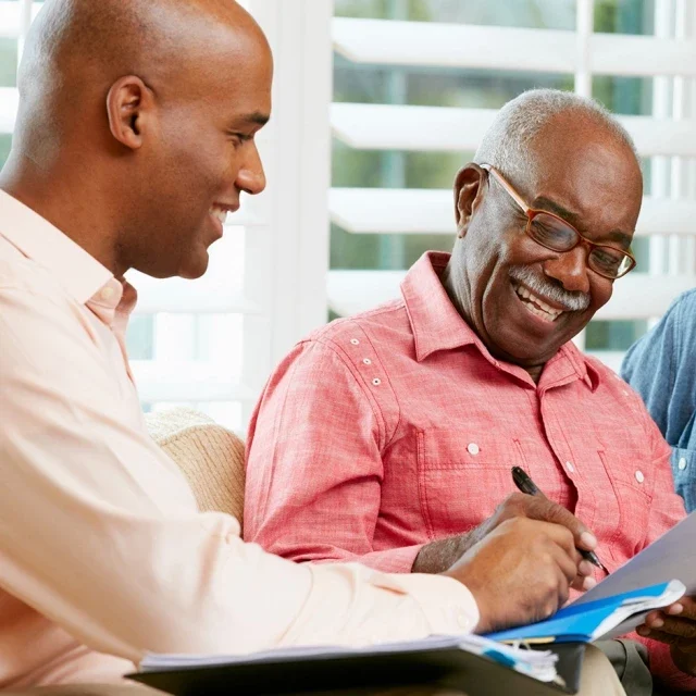 Man and older man signing documents