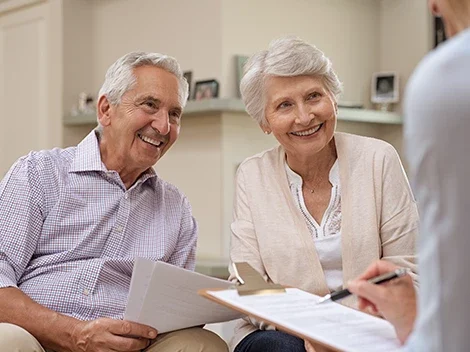 Older man and woman discussing finances with nurse