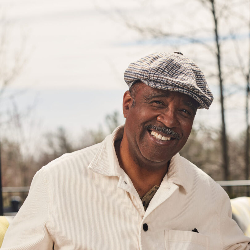 senior with a hat smiling